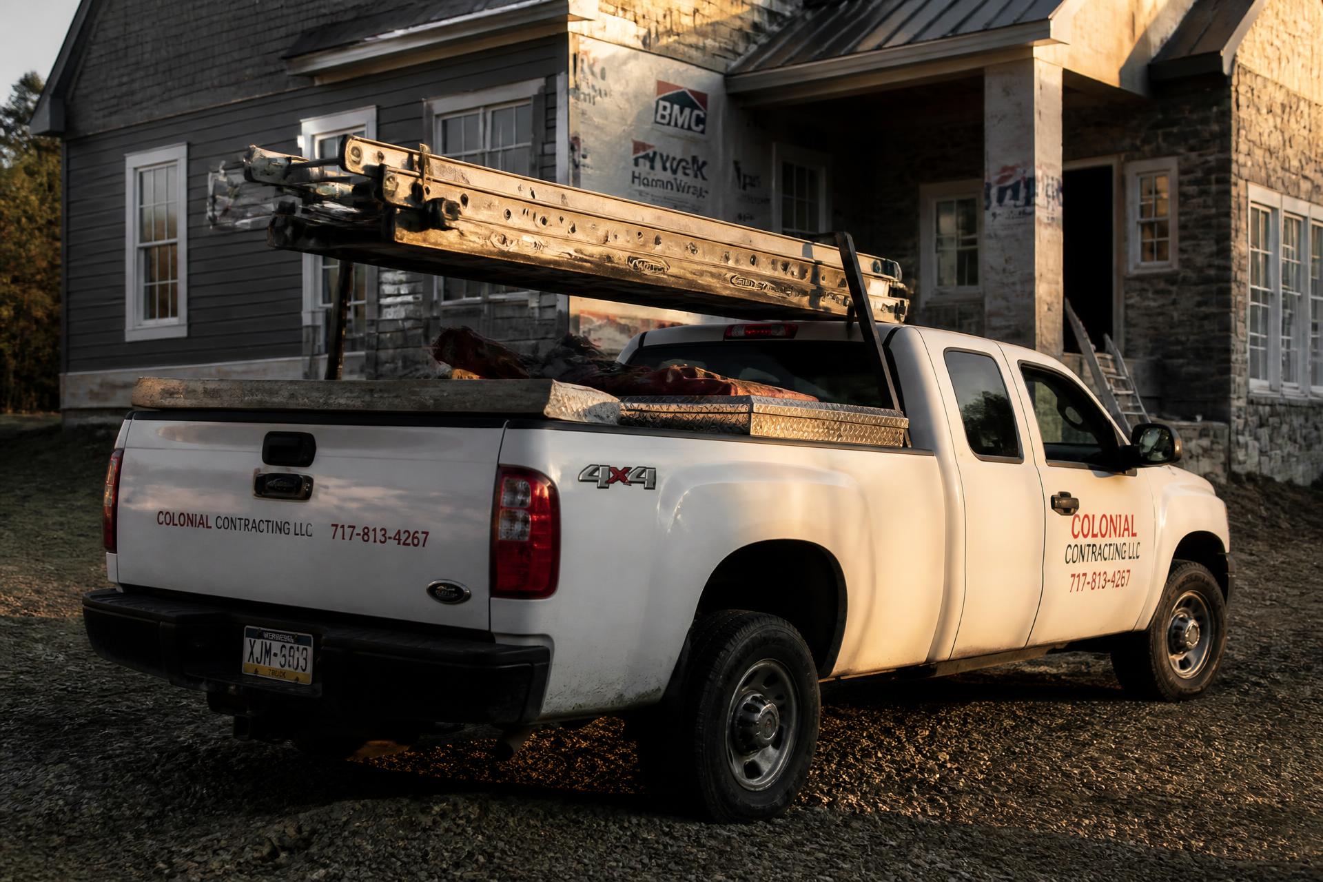 Contractor work truck parked at a residential job site at golden hour